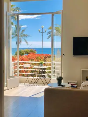 a living room with a view of the ocean at Stunning flat with sea view & garden on Promenade dA in Nice