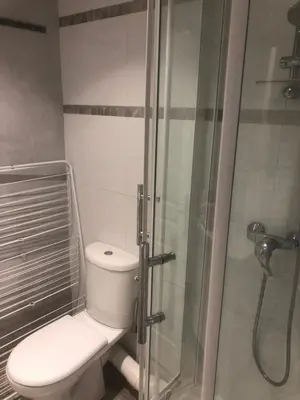 a bathroom with a toilet and a glass shower at Villefranche in Villefranche-sur-Mer