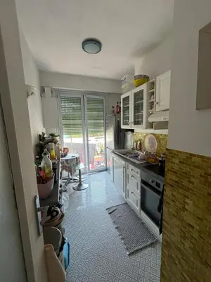 a kitchen with a sink and a stove top oven at Appartement Nice promenade des anglais in Nice