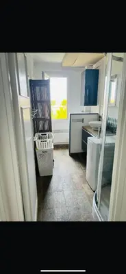 a kitchen with a chair in the middle of a room at Appartement F2 Nice Ouest in Nice