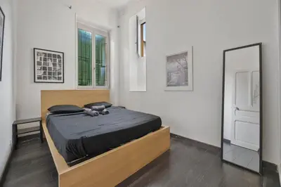 a bedroom with a bed and a large mirror at Nice et confortable 2 pièces cozy in Nice