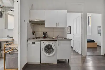 a kitchen with a washing machine and a sink at Nice et confortable 2 pièces cozy in Nice