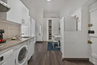 a kitchen with a washer and a white refrigerator at Nice et confortable 2 pièces cozy in Nice