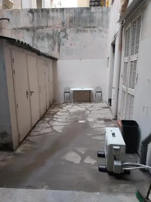 an empty room with a table and chairs in a building at Studio Carré d 'Or - 5 minutes de la mer in Nice