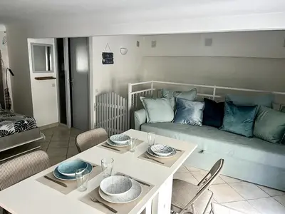 a living room with a table and a couch at Cozy apartement near the beach with with Aircon in Nice