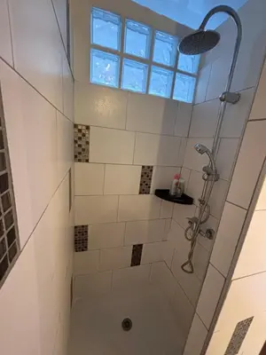 a bathroom with a shower with a window at Cosy Rooftop Studio Nice Centre in Nice