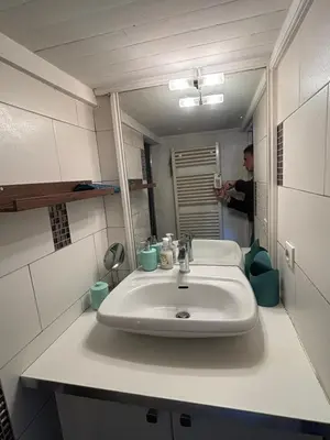 a man taking a picture of a bathroom sink at Cosy Rooftop Studio Nice Centre in Nice