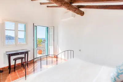 a bedroom with a bed and a desk and a window at #50 Contesso Duplex -1BDR, Sea View Terrace & AC in Villefranche-sur-Mer