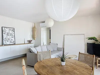 a living room with a table and a couch at Azur in Cagnes-sur-Mer