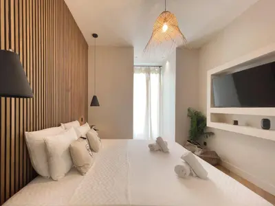 a bedroom with a large white bed with towels on it at Appartement Niçois - 3 Pièces au Centre in Nice