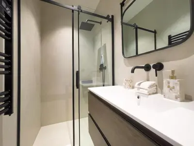 a bathroom with a sink and a glass shower at Appartement Niçois - 3 Pièces au Centre in Nice
