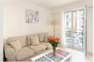 a living room with a couch and a table at 2 pièces centre ville-Balcon in Nice