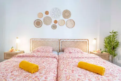 a bedroom with a large bed with two yellow pillows at Modern and elegant, air-conditioned, city centre - HDP2 in Nice