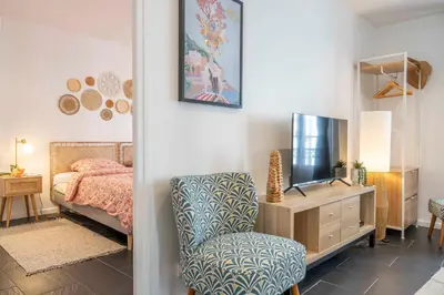 a bedroom with a bed and a chair and a tv at Modern and elegant, air-conditioned, city centre - HDP2 in Nice