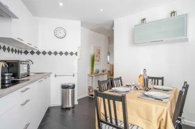 a kitchen with a table and chairs in a room at Modern and elegant, air-conditioned, city centre - HDP2 in Nice