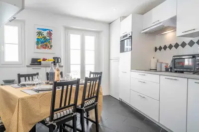 a kitchen and dining room with a table and chairs at Modern and elegant, air-conditioned, city centre - HDP2 in Nice