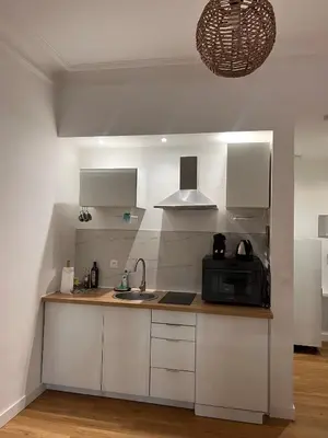 a kitchen with white cabinets and a sink and a microwave at Simply the best! All you need! in Nice