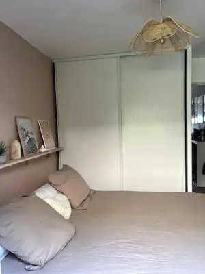 a bedroom with a bed with two pillows on it at Appartement calme vue mer in Saint-Laurent-du-Var