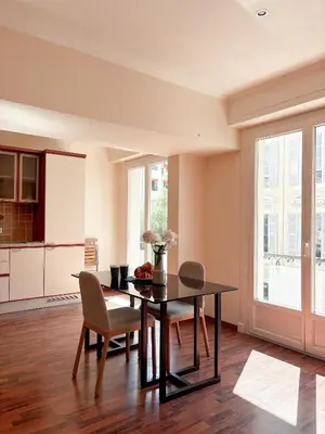 a kitchen and dining room with a table and chairs at Hyper-centre, Air-conditioned apartment with balcony in Nice