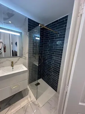 a bathroom with a glass shower and a sink at MOON 21 in Nice