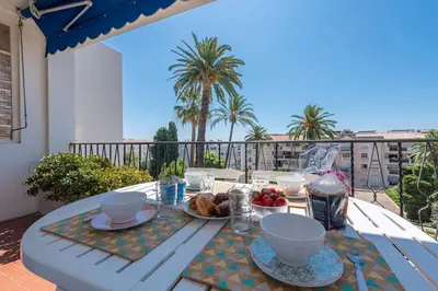 a table with food on top of a balcony at Beaulieu Garden Apartment in Beaulieu-sur-Mer