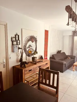a living room with a couch and a table at Magnifique studio avec terrasse et jardin in Nice