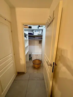 a hallway with an open door to an open refrigerator at Magnifique studio avec terrasse et jardin in Nice