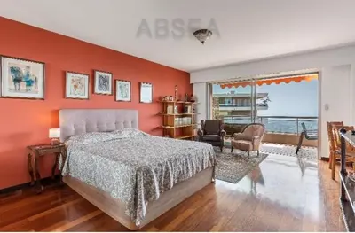 a bedroom with a bed and an orange wall at Absea Nice Belles Terres 4 in Nice