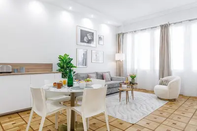 a living room with a table and a couch at Capitol Close To The Beach - Happy Rentals in Nice