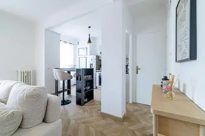 a white living room with a white couch and a table at Wide & Cozy 1 Bdr Downtown in Nice