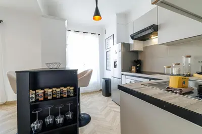 a kitchen with a black and white counter top at Wide & Cozy 1 Bdr Downtown in Nice