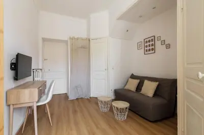 a living room with a couch and a table at Studio cosy dans une belle copropriete classee in Nice