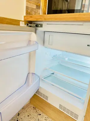 an empty refrigerator with its door open at Petit Bijou 1 Pers Centrale WiFI in Nice