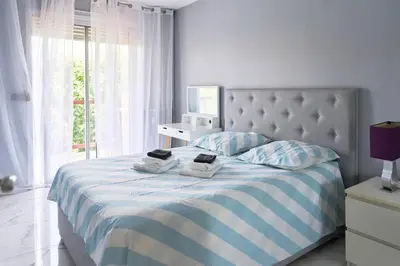 a bedroom with a bed with two towels on it at Appartement 3 pièces Nice-Ouest in Nice