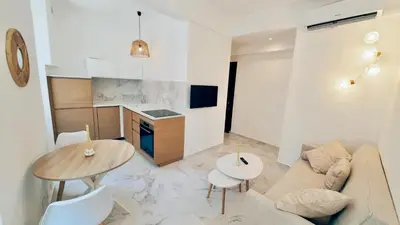 a living room with a couch and a table at Nest In Nice in Nice