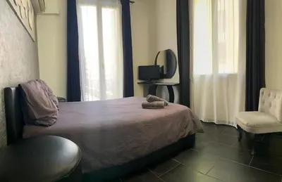 a bedroom with a bed with a stuffed animal on it at République in Nice