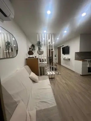 a living room with a bed and a kitchen at Appartement-Centre ville -Climatisé-Terrasse-Parking in Cagnes-sur-Mer