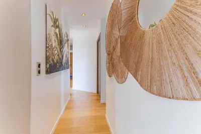 a hallway with a mirror on the wall at 33 MARINONI AP4438 by Riviera Holiday Homes in Beaulieu-sur-Mer