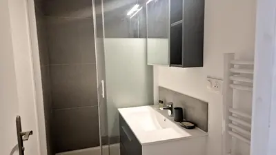 a bathroom with a sink and a shower at Superbe appartement 3P neuf - terrasse - barbecue in Nice