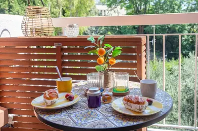 a table with two plates of food on a patio at Appartement cosy lumineux avec balcon in Nice