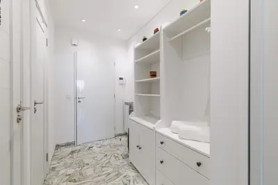 a white bathroom with a shower and white cabinets at Sea View & Terrace Promenade des Anglais in Nice