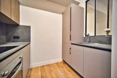 a kitchen with white cabinets and a sink at MAYERBEER - Apartment 2 bedrooms with balcony in Nice