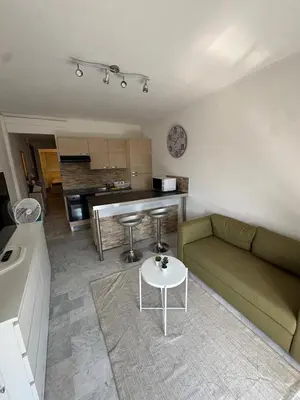 a living room with a couch and a table at Apartment in Cros de Cagnes in Cagnes-sur-Mer