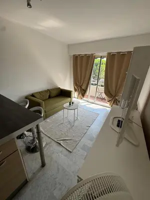 a living room with a couch and a table at Apartment in Cros de Cagnes in Cagnes-sur-Mer