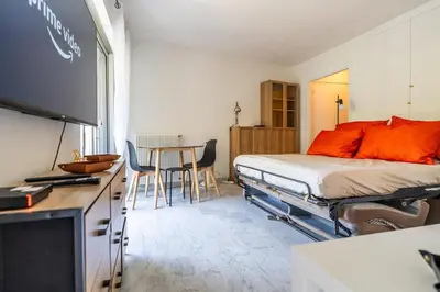 a bedroom with a bed and a table with chairs at L'Échappée Belle in Nice