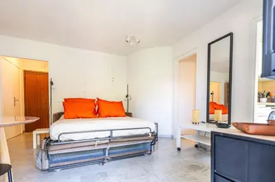 a bedroom with a bed with orange pillows and a mirror at L'Échappée Belle in Nice