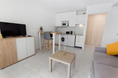 a living room with a couch and a table at Le Seaside - Beach - Tram - Airport - AC in Nice