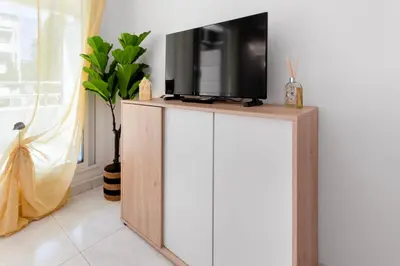 a tv on top of a cabinet in a room at Le Seaside - Beach - Tram - Airport - AC in Nice