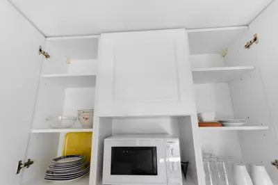 a white refrigerator with a microwave in a kitchen at Le Seaside - Beach - Tram - Airport - AC in Nice