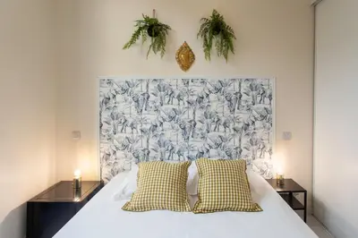 a white bed with two pillows in a bedroom at #3 Mascoinat 1BDR Old Town, near beach Fan & WIFI in Nice